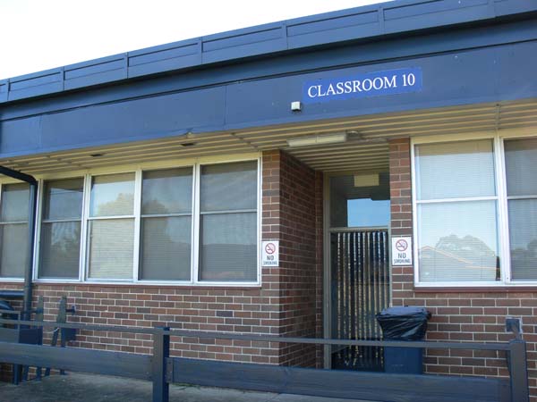 Single storey brick building showing entry to training room. There is a door in centre and windows either side. Classroom 10 sign above door.